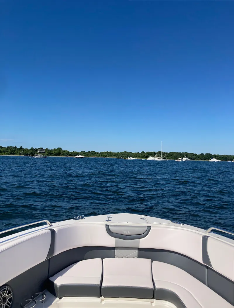 Slide: The Image of Chaparral 280 OSX 2020 boat on calm water under clear blue sky. - 14