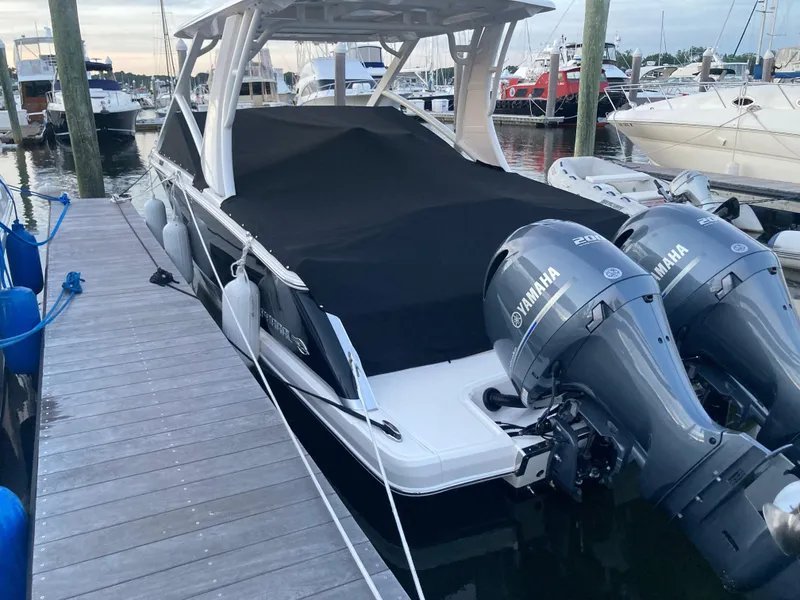 Slide: The Image of 2020 Chaparral 280 OSX boat docked with twin Yamaha outboard engines. - 2