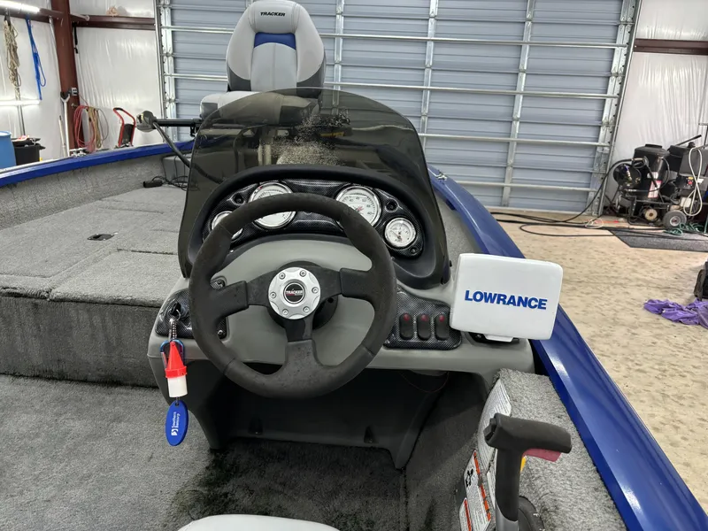 Slide: The Image of 2012 Tracker Pro Team 175 TF boat dashboard with Lowrance fishfinder in a garage. - 10