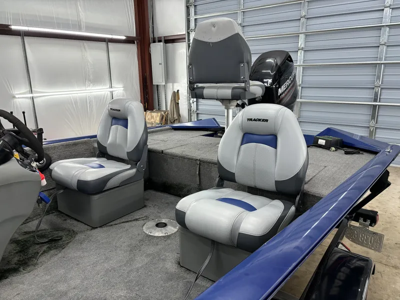 Slide: The Image of 2012 Tracker Pro Team 175 TF boat interior with seating and Mercury engine. - 11