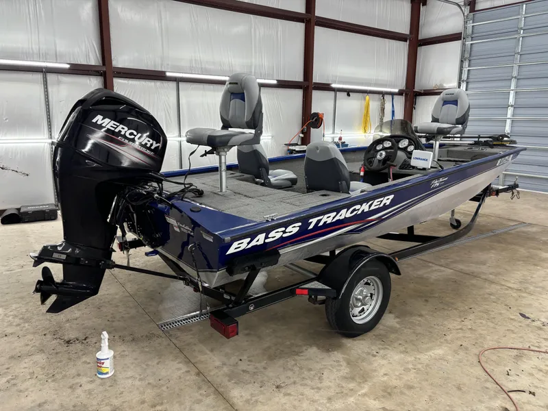 Slide: The Image of 2012 Tracker Pro Team 175 TF bass boat with Mercury engine in a garage. - 3