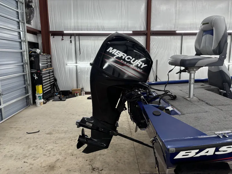 Slide: The Image of 2012 Tracker Pro Team 175 TF boat with Mercury outboard motor in a garage. - 4