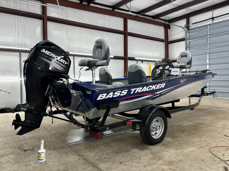 Slide: The Image of 2012 Tracker Pro Team 175 TF bass boat in a garage with Mercury outboard motor. - 7
