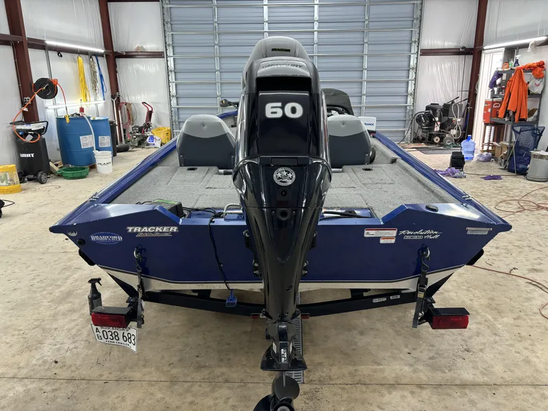 Slide: The Image of 2012 Tracker Pro Team 175 TF boat in a garage, featuring a 60 HP motor. - 8