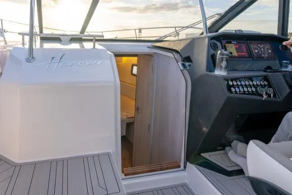 Slide: The Image of 2025 Hanover 387 Grey & Black Edition Outboard interior with modern dashboard and cabin entrance. - 10
