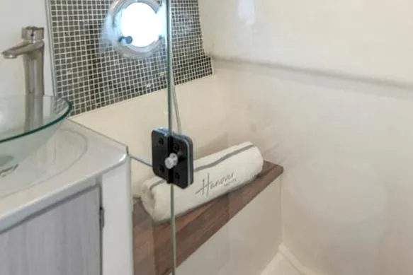 Slide: The Image of Interior of 2025 Hanover 387 Grey & Black Edition Outboard, featuring modern bathroom design. - 15