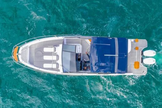 Slide: The Image of Aerial view of 2025 Hanover 387 Grey & Black Edition Outboard on turquoise water. - 4