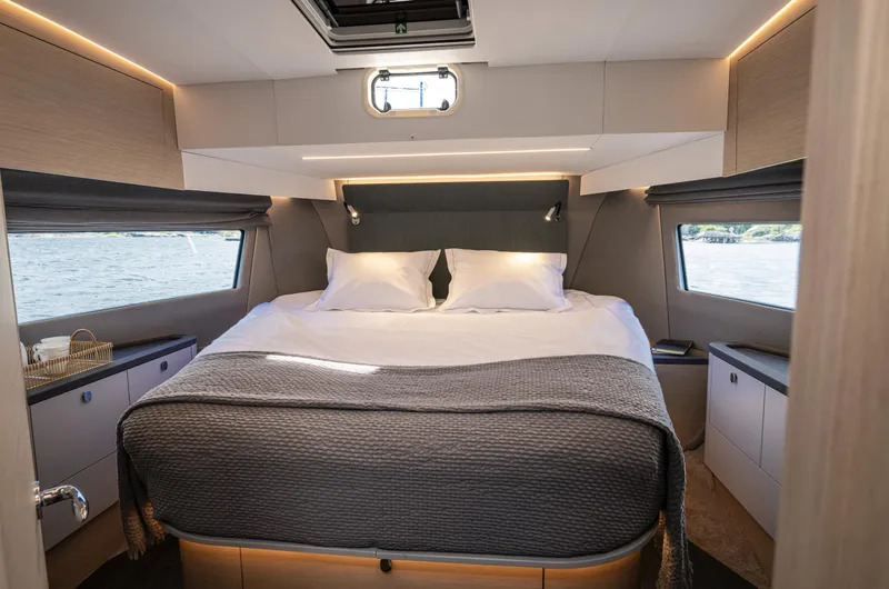 Slide: The Image of Luxurious bedroom interior of 2025 Nimbus 495 Flybridge yacht with modern design and cozy bedding. - 24