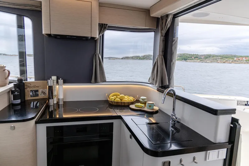 Slide: The Image of Modern kitchen interior on 2025 Nimbus 495 Flybridge yacht with scenic ocean view. - 7