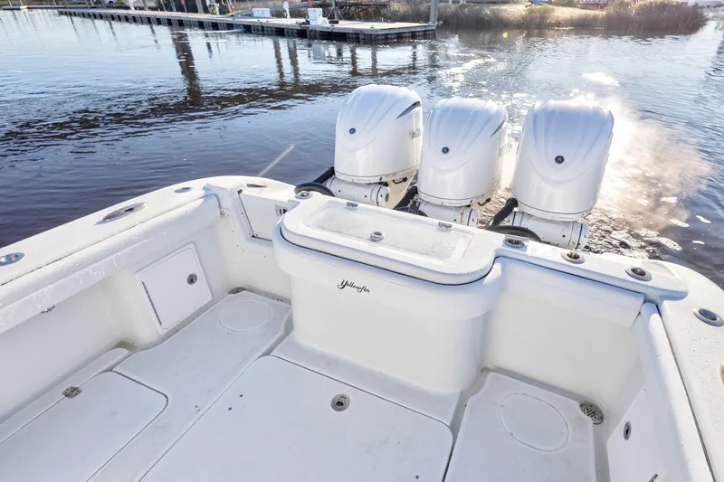 Slide: The Image of 2020 Yellowfin 36 Offshore boat with triple outboard engines on calm water. - 10