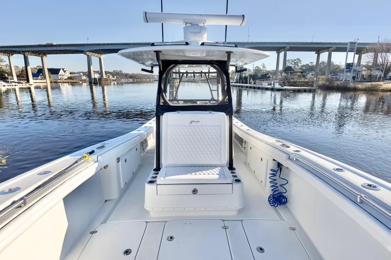 Slide: The Image of 2020 Yellowfin 36 Offshore boat on calm water near a bridge. - 11