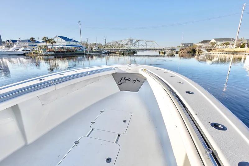 Slide: The Image of 2020 Yellowfin 36 Offshore boat on calm water near marina and bridge. - 12