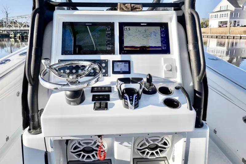 Slide: The Image of 2020 Yellowfin 36 Offshore boat console with navigation screens and controls. - 13