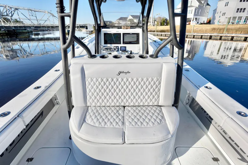 Slide: The Image of 2020 Yellowfin 36 Offshore boat with white quilted seating, docked near waterfront homes. - 14