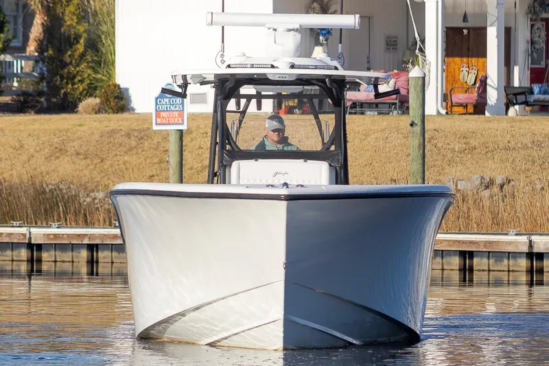 Slide: The Image of 2020 Yellowfin 36 Offshore boat docked near waterfront cottages. - 2