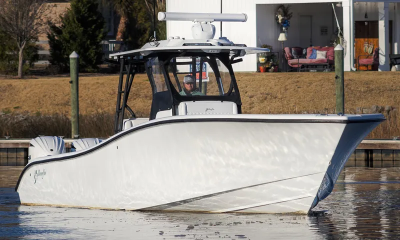 Slide: The Image of 2020 Yellowfin 36 Offshore boat on calm water near a dock. - 3