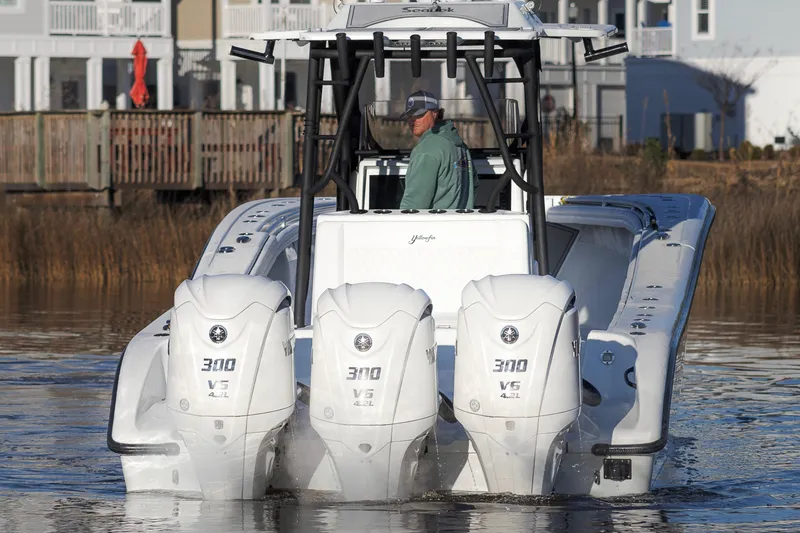 Slide: The Image of 2020 Yellowfin 36 Offshore boat with triple 300 V6 engines on calm water. - 7