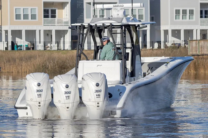 Slide: The Image of 2020 Yellowfin 36 Offshore boat with triple 300 V6 engines on calm water. - 8