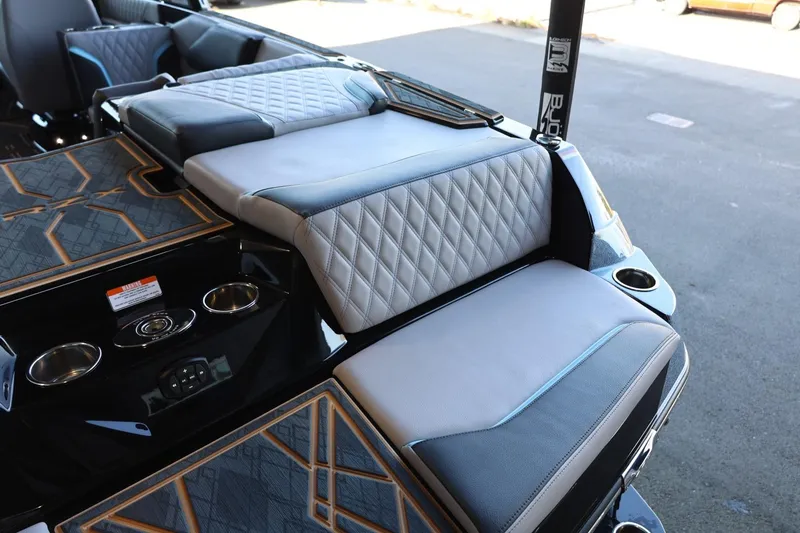 Slide: The Image of 2025 Tigé 24RZX boat interior with quilted seats and cup holders. - 19