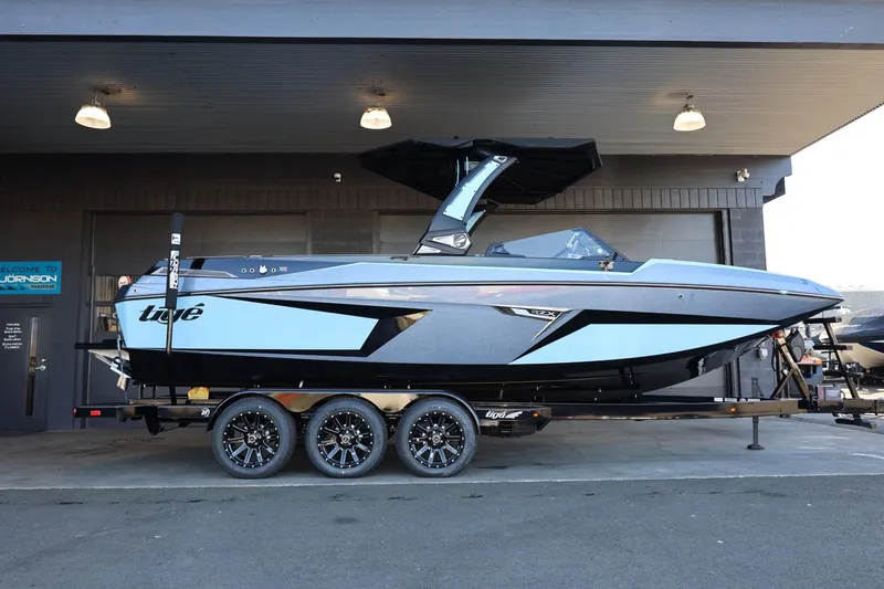 Slide: The Image of 2025 Tigé 24RZX boat on trailer, sleek design, parked in a garage. - 2