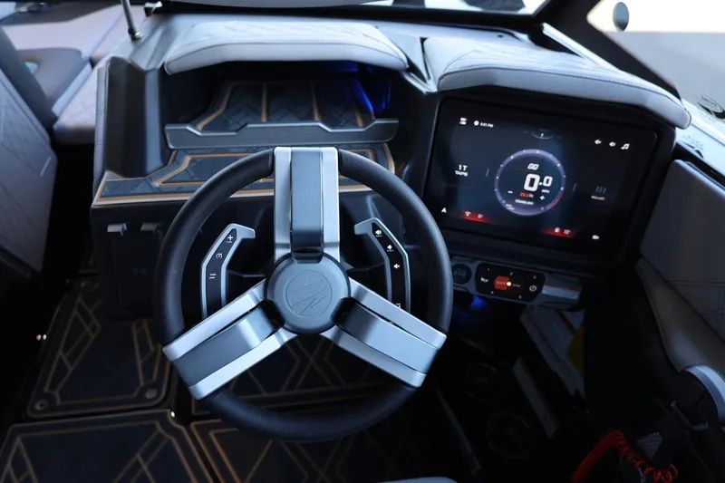 Slide: The Image of 2025 Tigé 24RZX boat dashboard with modern steering wheel and digital display. - 28