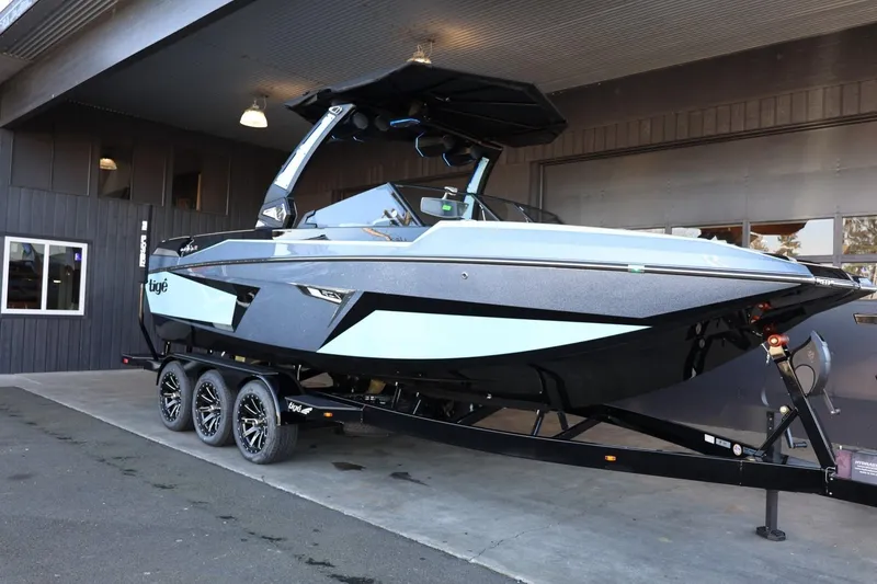 Slide: The Image of 2025 Tigé 24RZX boat on trailer, sleek design, parked indoors. - 3