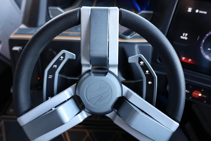 Slide: The Image of Steering wheel of 2025 Tigé 24RZX boat, featuring modern controls and sleek design. - 34