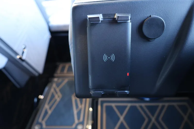 Slide: The Image of 2025 Tigé 24RZX interior with wireless charging pad and stylish floor design. - 40