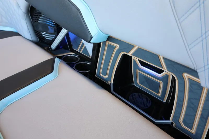 Slide: The Image of 2025 Tigé 24RZX interior with modern design, featuring cup holders and ambient lighting. - 45