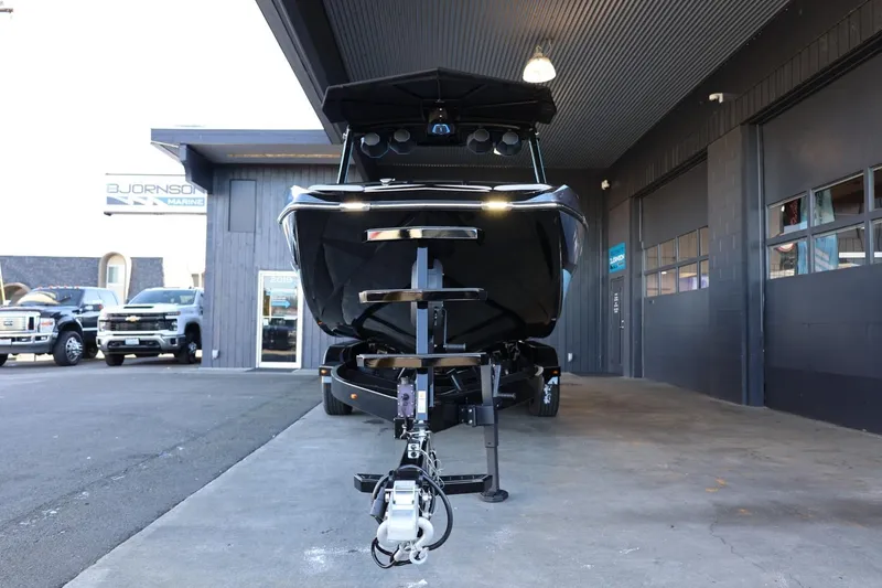 Slide: The Image of 2025 Tigé 24RZX boat on trailer, parked outside dealership. - 6