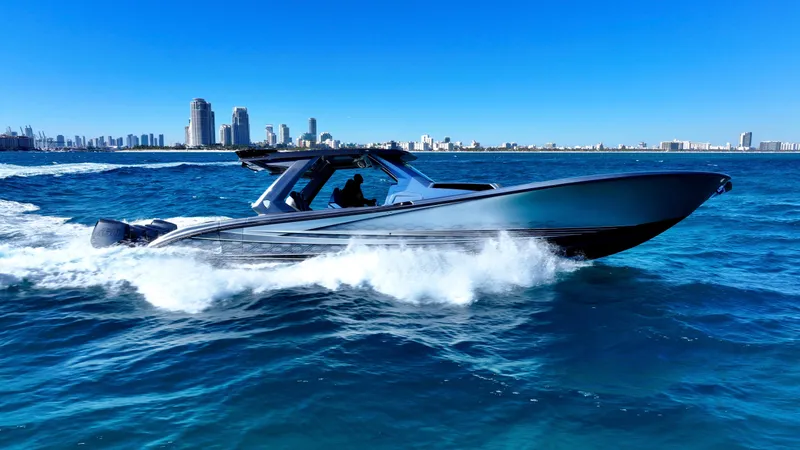 Slide: The Image of 2024 Adrenaline 47 Reaper speedboat cruising on blue ocean near city skyline. - 33