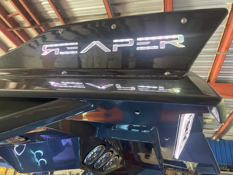 Slide: The Image of 2024 Adrenaline 47 Reaper boat with illuminated logo and sleek design. - 44