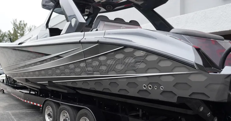 Slide: The Image of 2024 Adrenaline 47 Reaper boat with sleek, modern design on a trailer. - 6