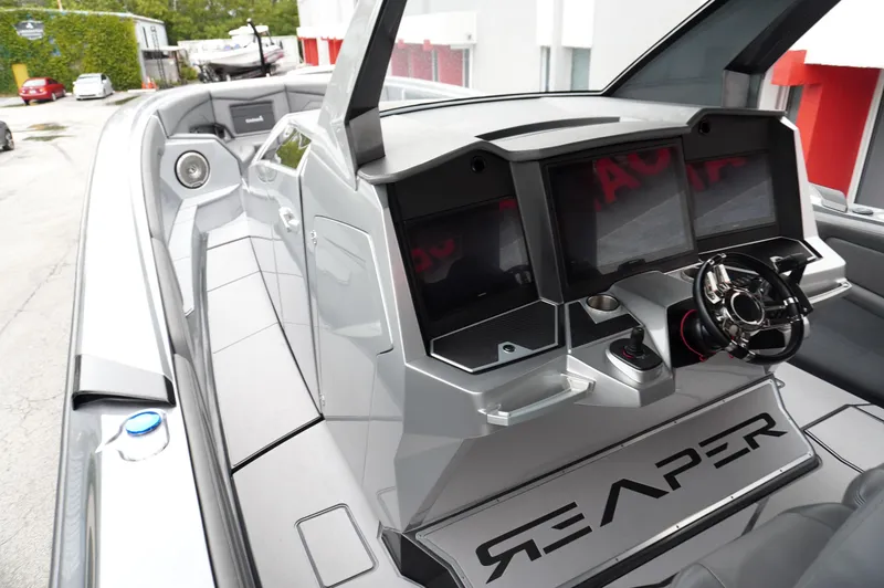 Slide: The Image of 2024 Adrenaline 47 Reaper boat interior with modern dashboard and steering wheel. - 7