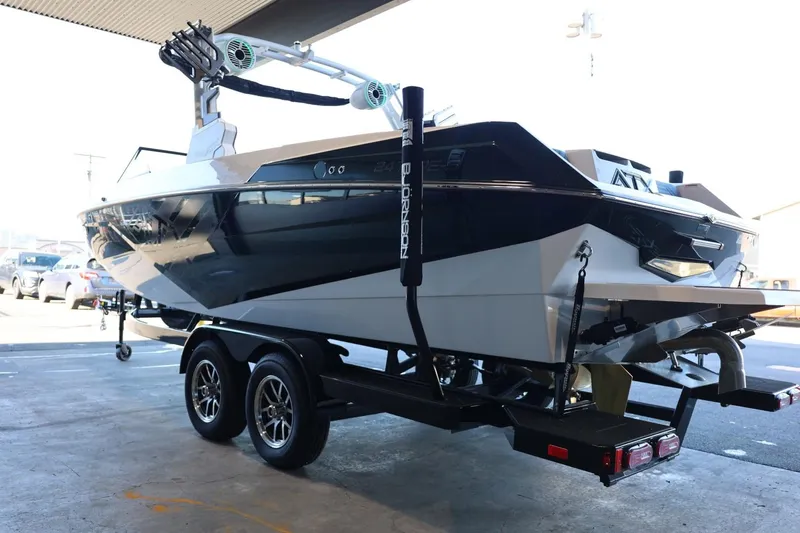 Slide: The Image of 2025 ATX Surf Boats 24 Type-S on trailer, sleek design, parked indoors. - 10