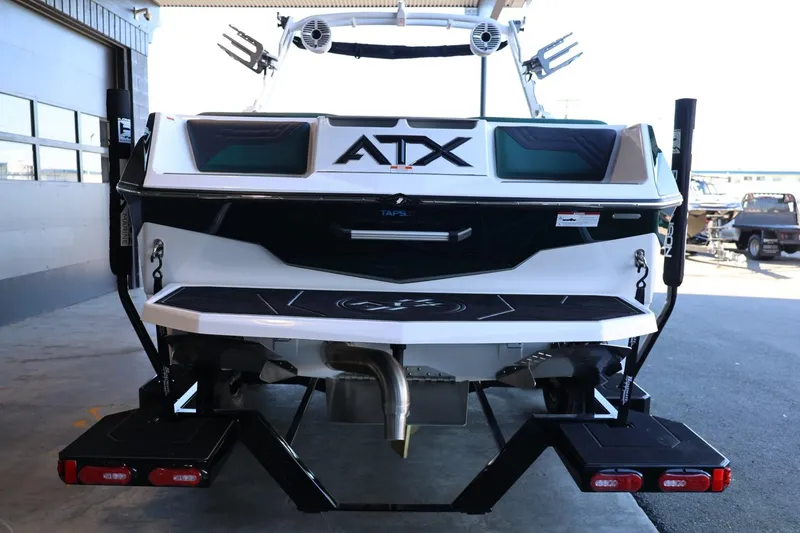 Slide: The Image of 2025 ATX Surf Boats 24 Type-S, rear view in a garage setting. - 11