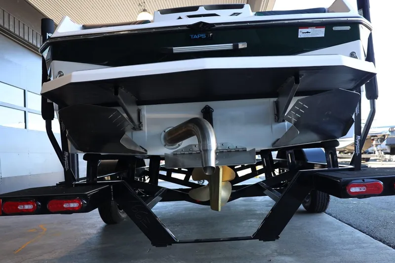 Slide: The Image of 2025 ATX Surf Boats 24 Type-S rear view, showcasing propeller and trailer. - 12