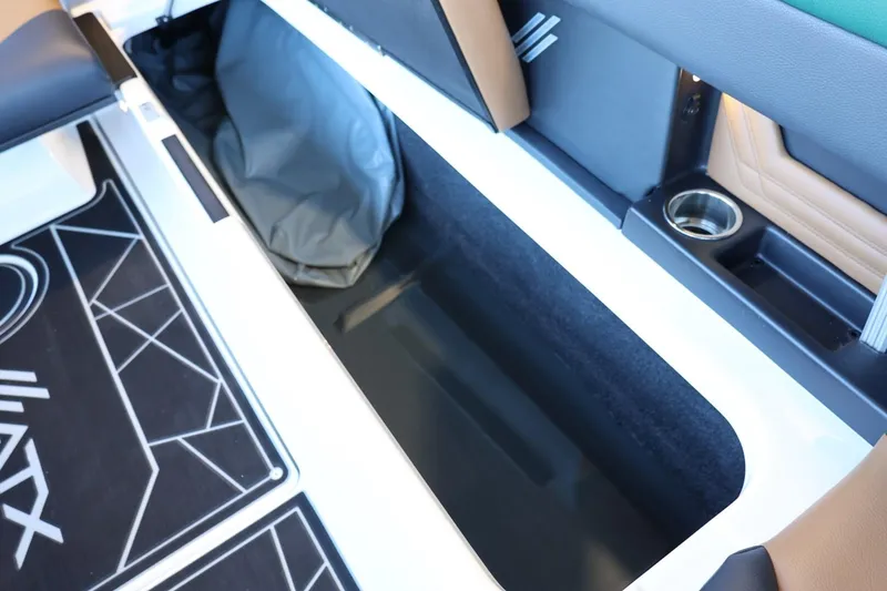 Slide: The Image of 2025 ATX Surf Boats 24 Type-S interior storage compartment with cup holder and mat design. - 27
