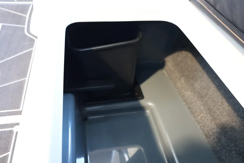 Slide: The Image of 2025 ATX Surf Boats 24 Type-S storage compartment with carpeted interior and sleek design. - 29