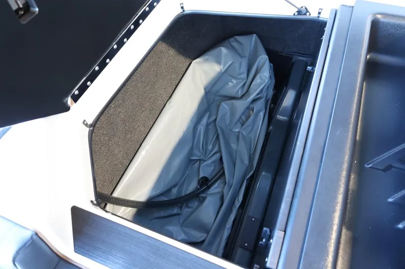 Slide: The Image of 2025 ATX Surf Boats 24 Type-S storage compartment with gray interior lining. - 35