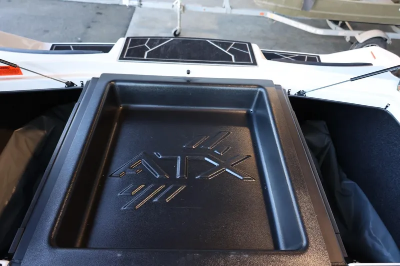Slide: The Image of 2025 ATX Surf Boats 24 Type-S storage compartment with logo detail. - 36