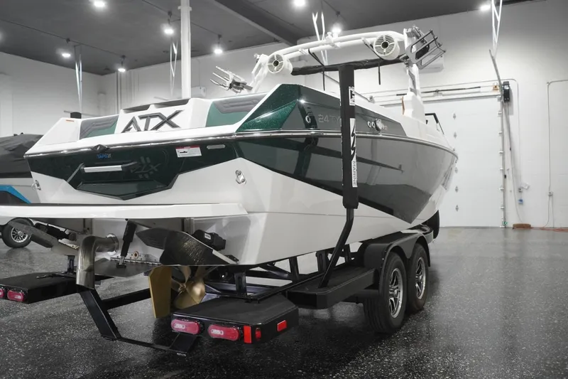 Slide: The Image of 2025 ATX Surf Boats 24 Type-S on trailer in showroom, rear view. - 42