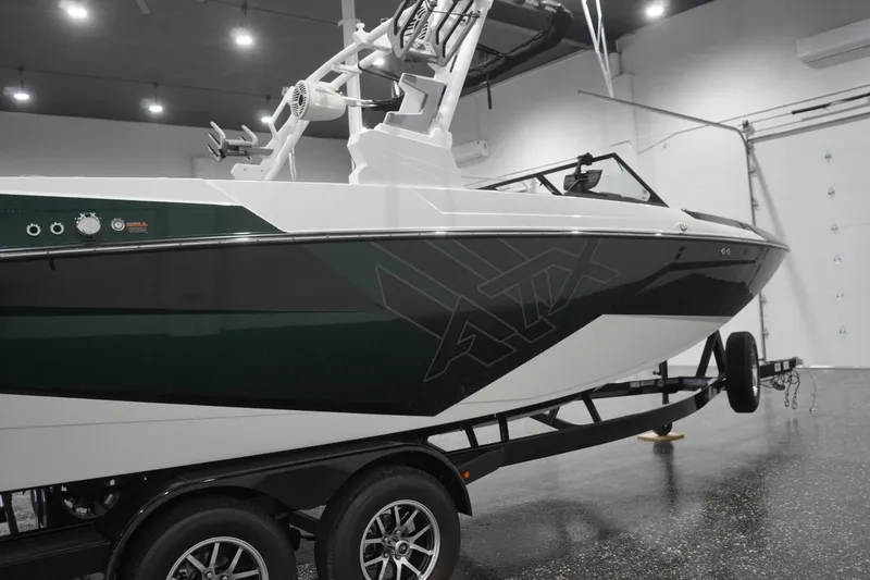 Slide: The Image of 2025 ATX Surf Boats 24 Type-S on trailer in showroom, sleek design, modern features. - 45