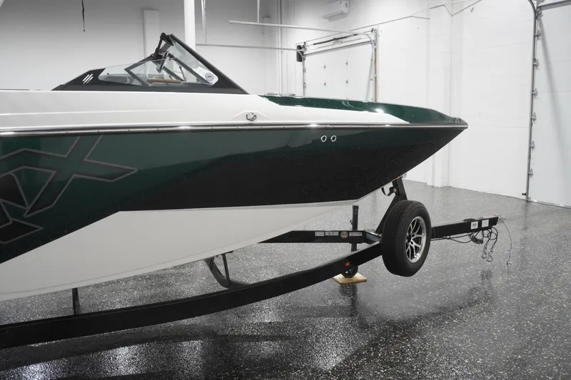 Slide: The Image of 2025 ATX Surf Boats 24 Type-S on trailer in a garage setting. - 48