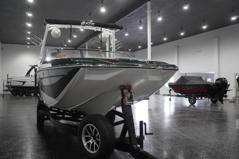 Slide: The Image of 2025 ATX Surf Boats 24 Type-S displayed in a showroom on a trailer. - 52