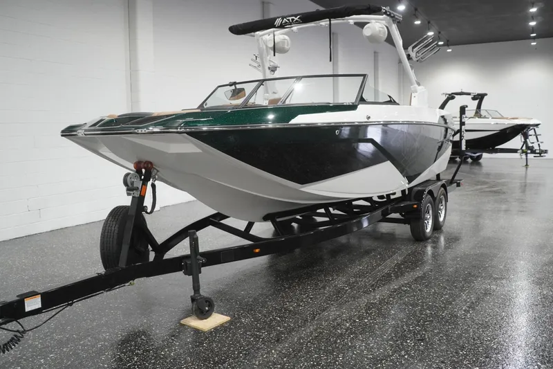 Slide: The Image of 2025 ATX Surf Boats 24 Type-S on trailer in showroom setting. - 54