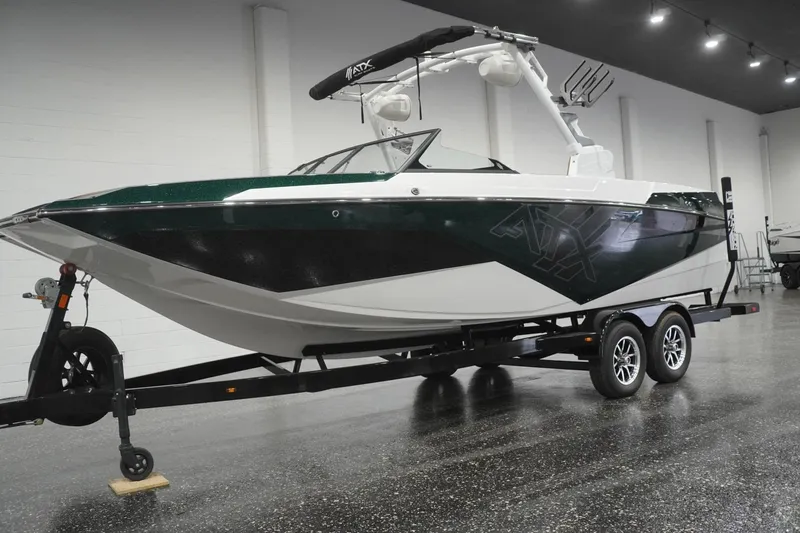 Slide: The Image of 2025 ATX Surf Boats 24 Type-S on trailer in showroom, sleek design. - 56