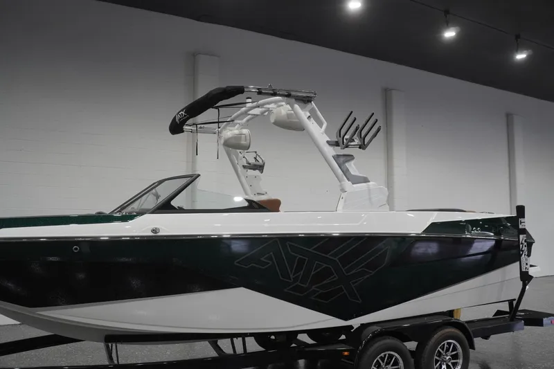 Slide: The Image of 2025 ATX Surf Boats 24 Type-S in showroom, featuring sleek design and modern wakeboard tower. - 58