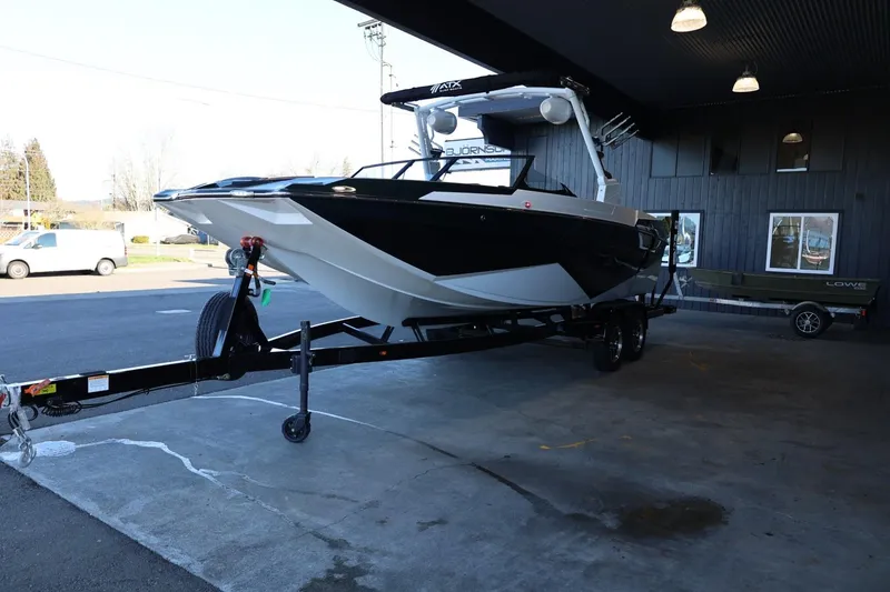 Slide: The Image of 2025 ATX Surf Boats 24 Type-S on trailer in a covered area. - 6