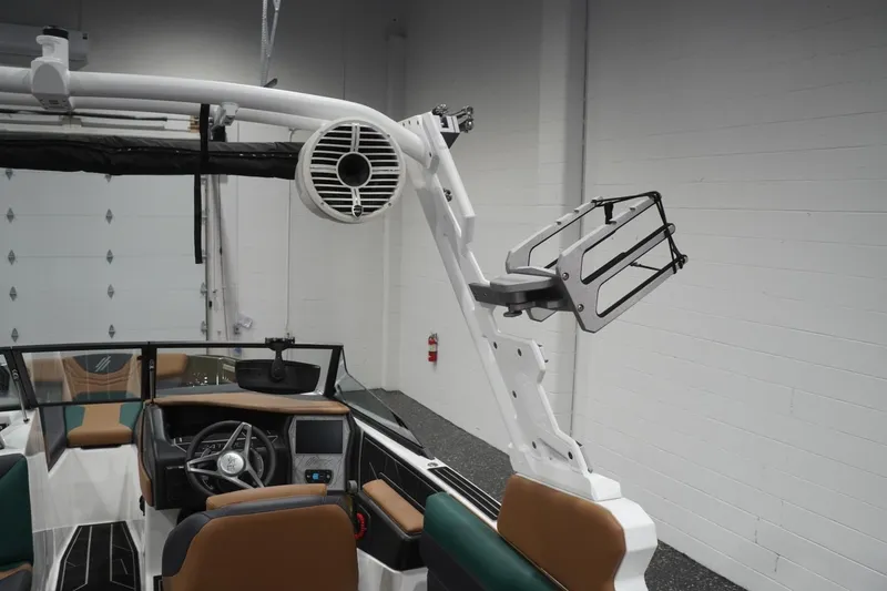 Slide: The Image of 2025 ATX Surf Boats 24 Type-S interior with steering wheel and speaker system. - 72